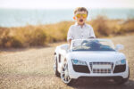 toddler driving a toy bmw