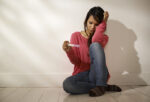 sad woman looking at pregnancy test