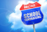 School fundraising sign printed on a traffic sign with the word next exit on a blue cloudy sky background
