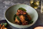 popcorn chicken in small bowl with 2 small drinks and piece of sample in purple tissue