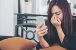 Woman upset looking at partner's phone