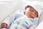 baby sleeping in light filled room