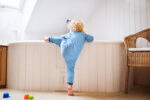 toddler climbing into bath