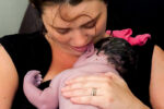 woman delivering baby at home