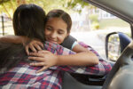 mother dropping girl off at achool