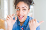 beauty hacks, woman with eyelash curler