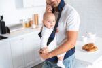 Dad with baby in carrier | parental leave