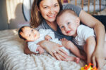 Toddler and newborn with mother
