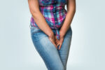Women clutching herself wanting to pee