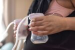 pregnant woman expressing breastmilk