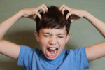 boy scratching head nits