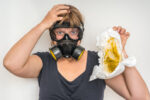 mum wearing gas mask changing dirty nappy