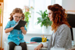 mother and daughter in office wearing glasses