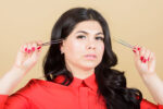 woman with tweezers, mum plucks babys unibrow
