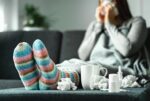 woman on sofa with tissues