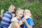 three happy young boys, siblings