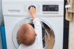 toddler at washing machine