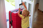 Toddler with suitcase at airport