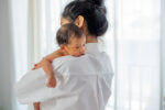 baby on mothers shoulder