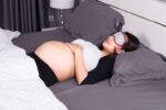 pregnant mum asleep on back