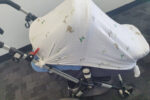 pram covered in muslin wrap