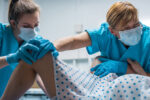 midwives delivering baby
