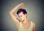 teen smelling armpits
