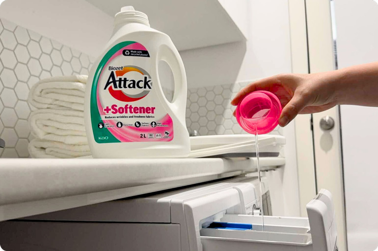 Pouring Biozet Attack Plus Softener liquid into the machine