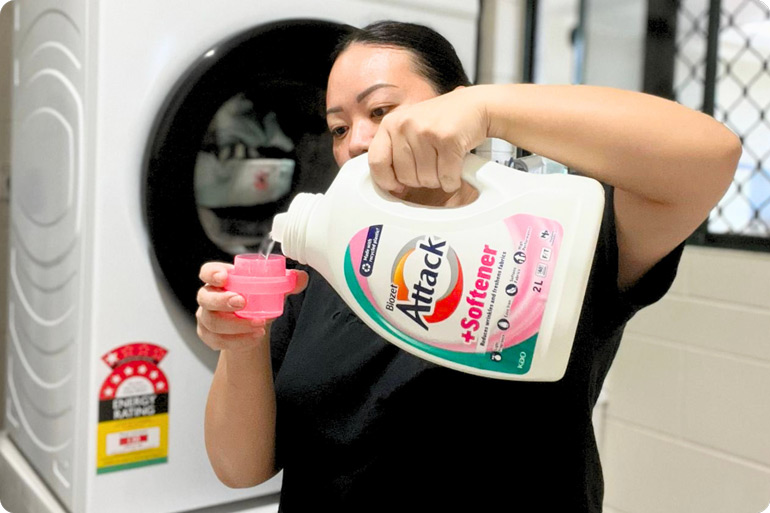 Mum pouring Biozet Attack Plus Softener liquid 