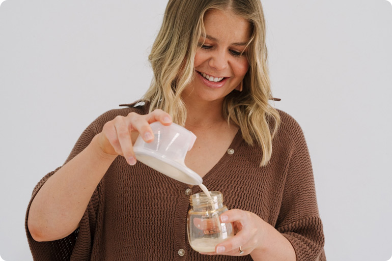 We Asked Mums to Vote for the Best Breast Pump in Australia. They Chose the Mumilk Ella. Again. 3 Woman pouring breast milk from The Ella Breast Pump