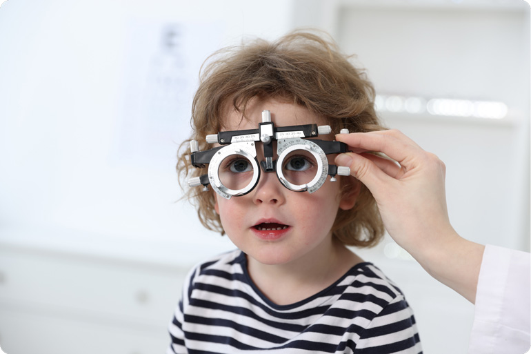 Child getting fitted for glasses - optical family health bills