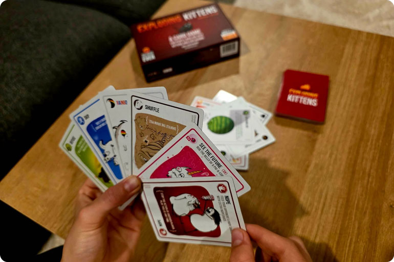 WIN a Copy of Exploding Kittens: Fierce, Sneaky, Strategic, and Absolutely Hilarious! 1 Exploding Kittens Card Game choosing card