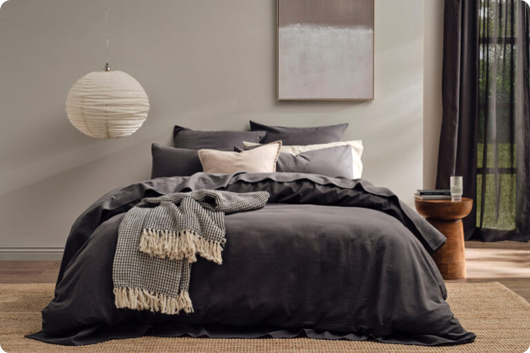 The Sensory Bedtime Tweaks That Help Exhausted Mums Wind Down Koo Home Store made bed with a soft textured throw folded across the end