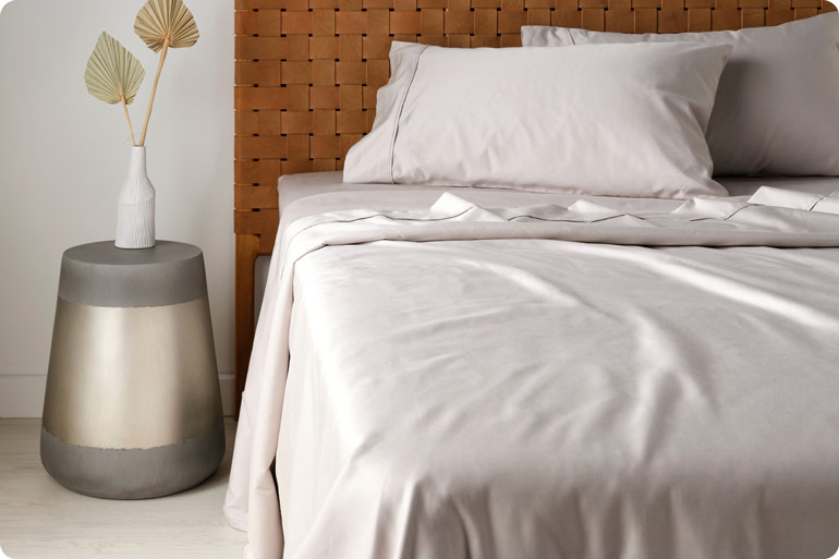 The Sensory Bedtime Tweaks That Help Exhausted Mums Wind Down 3 Bed made up with smooth bamboo cotton sheets and pillowcases