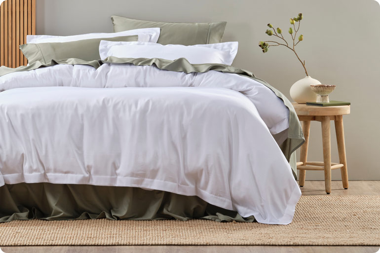 The Sensory Bedtime Tweaks That Help Exhausted Mums Wind Down 2 Freshly made bed with crisp white cotton pillowcases and sheets